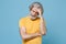 Displeased tired elderly gray-haired mustache bearded man in casual yellow t-shirt posing isolated on blue background