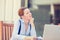 Displeased worried business woman sitting in front of laptop computer