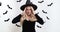 Displeased young witch woman in black halloween costume massaging her temples, suffering from headache