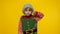 Displesed kid girl in Christmas elf Santa helper costume keeps thumb down and shows dislike gesture