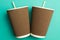 Disposable cups for hot drinks on a turquoise backgrounds. Paper cups
