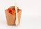 Disposable food, cardboard packaging with tomatoes and a wooden fork. Eco-friendly food packaging