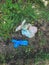 Disposable medical gloves on ground with single use plastic trash. How to dispose used medical gloves right after coronavirus