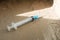 a disposable medical syringe lies on the street. The problem of drug addiction