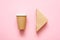 Disposable paper cup and triangular sandwich container on a pink background