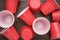 Disposable plastic cups on wooden background. top view of used plastic cups on the table. end of the party concept