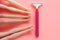 Disposable shaving machine for women on a pink pastel background, flatley, copy space