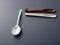 disposable spoon on a white table, AI Generated