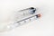 Disposable syringe. Plastic insulin syringe. The insulin syringe with the lid open shows sharp needles. Injection medicine.