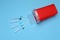 Disposable syringes, needles and sharps container on light blue background