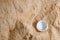Disposable water bottle cap on sand background