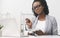 Dissatisfied Afro Businesswoman Taking Notes Organizing Schedule At Work