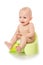 Dissatisfied baby cries on a pot. Infant child baby boy toddler sitting on potty toilet isolated on a white background. spoiled