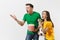 Dissatisfied couple, woman, man, football fans in yellow green t-shirt cheer up support team with soccer ball bucket of