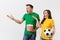 Dissatisfied couple, woman, man, football fans in yellow green t-shirt cheer up support team with soccer ball bucket of