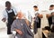 Dissatisfied elderly client with perplexed African hairdresser