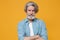 Dissatisfied elderly gray-haired mustache bearded man in casual blue shirt posing isolated on yellow background studio