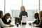 Dissatisfied female executive scolding employees for bad work at