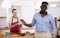 Dissatisfied husband quarreling with his wife in the kitchen during breakfast