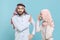 Dissatisfied irritated couple friends arabian muslim man wonam in keffiyeh kafiya ring igal agal hijab clothes isolated