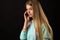 Dissatisfied teenager girl talking on mobile phone