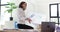 Dissatisfied upset woman sitting at the table and looking through documents in a modern office