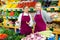 Dissatisfied young salesgirl listening to directions from experienced female colleague