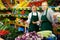 Dissatisfied young salesgirl listening to directions from experienced female colleague