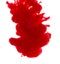 Dissolving clouds of red ink in water on a white background