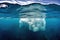 dissolving iceberg revealing underwater section through clear ocean