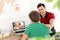 Distance learning, studying. Father helping his son with online school lesson during quarantine and lockdown due to Covid-