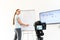 Distance study concept. A young female teacher, tutor is recording classes on a video