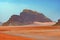 Distant Buttes in a Red Sand Desert