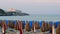 distant horizon closed umbrellas wind evening sea church on paradise beach sunset in Vieste Gargano - Italy