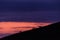 Distant horses silhouettes over a mountains against a beautiful coloured sky at dusk