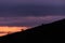 Distant horses silhouettes over a mountains against a beautiful coloured sky at dusk