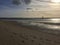 Distant Lighthouse Stands Guard Over Empty Beach