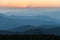 Distant mountain range and thin layer of clouds on the valleys