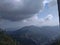 A distant panoramic rare view of villages and mountains with dark clouds in blue sky