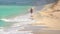 Distant person walks on the Cancun beach