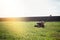 Distant photo red-and-black mowers standing on the manicured lawn in the morning sun