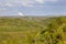 Distant Power Station in Forest Landscape