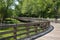 Distant runner on a very long elevated boardwalk winding through trees and over wetlands