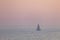 Distant Sailboat at Sunset