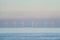 Distant shot of offshore wind energy farm of seven windmills in the ocean