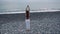 Distant shot of a yoga woman on beach.