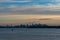 Distant silhouette of Sydney cityscape at dusk, on sunset