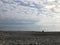 Distant silhouette of a tourist sitting on beach