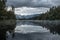 Distant snowy mountain is reflected in the Lake Matheson water