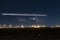 Distant thunderstorm and night trails over airport at night